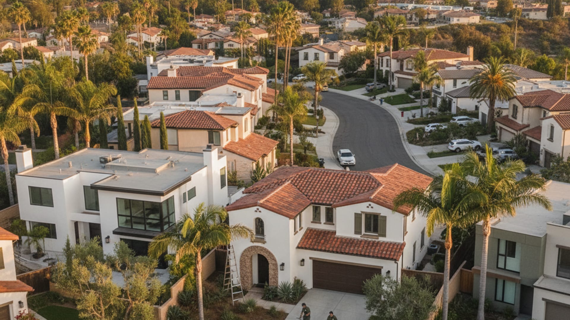 Aerial view of a San Diego County residential neighborhood with stucco homes and mature tree-lined streets at golden hour